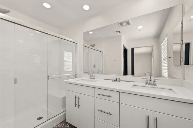 a bathroom with a sink double vanity and shower