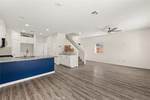 a view of kitchen with sink and wooden floor