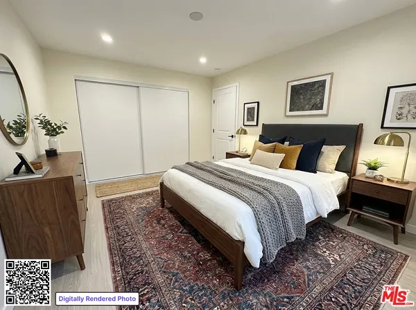a spacious bedroom with a bed and a dresser