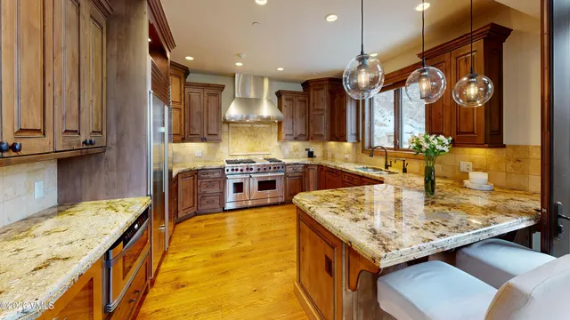 a large kitchen with a table and chairs