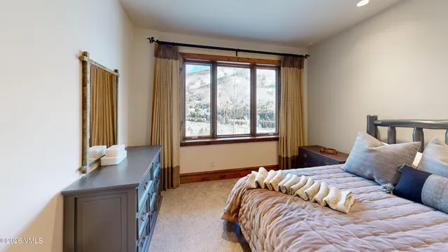 a bedroom with a large bed and a window