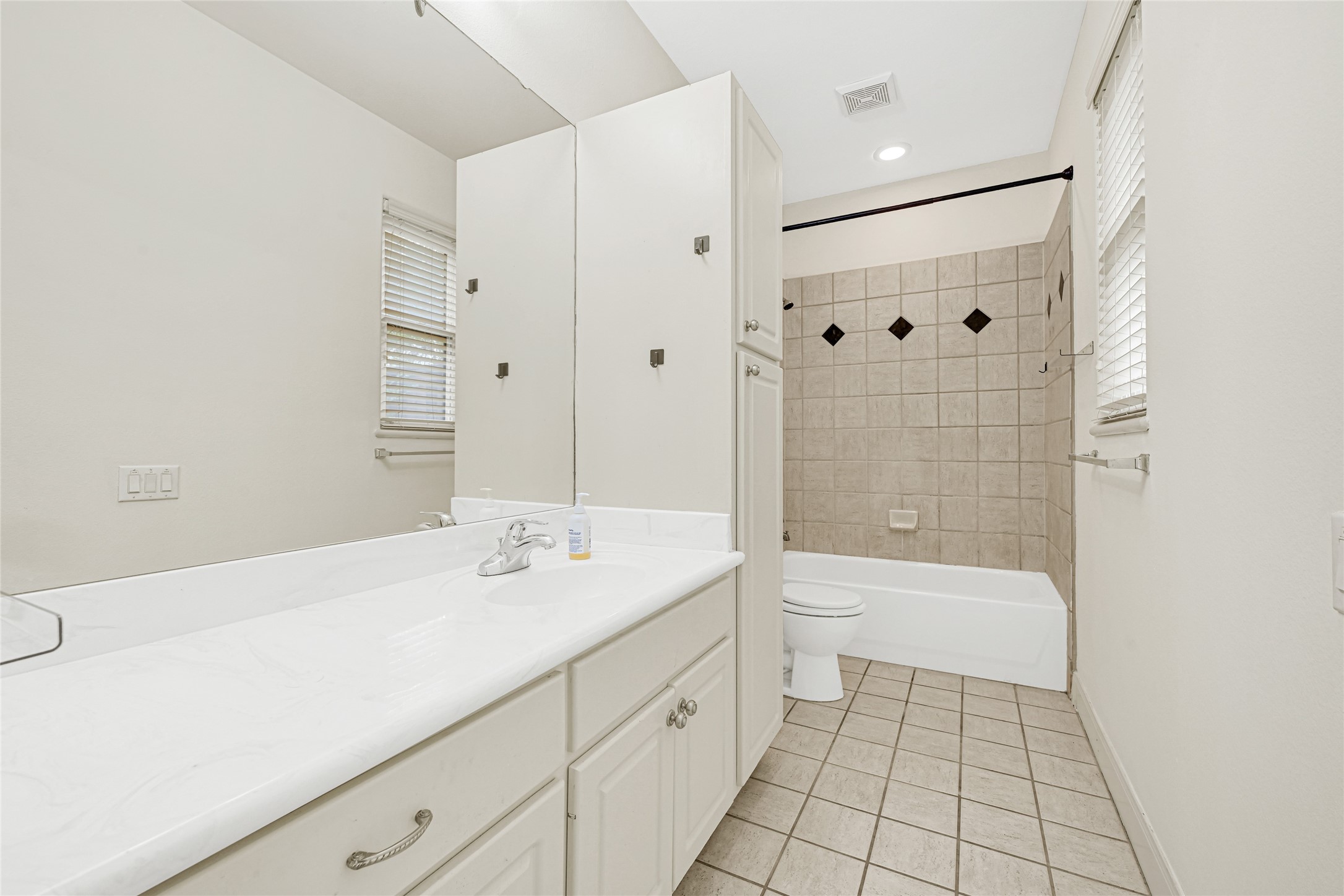 2414 Calumet Street, Unit B Houston, TX 77004 - Photo 6 of 27 a spacious bathroom with a shower sink and a mirror