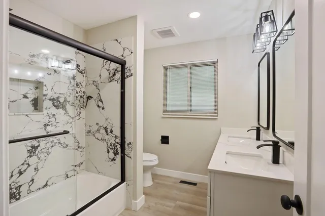 a bathroom with a sink toilet and shower