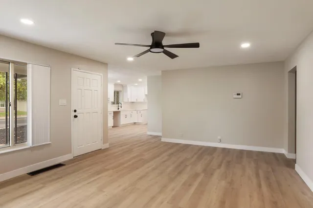 wooden floor in an empty room with a window