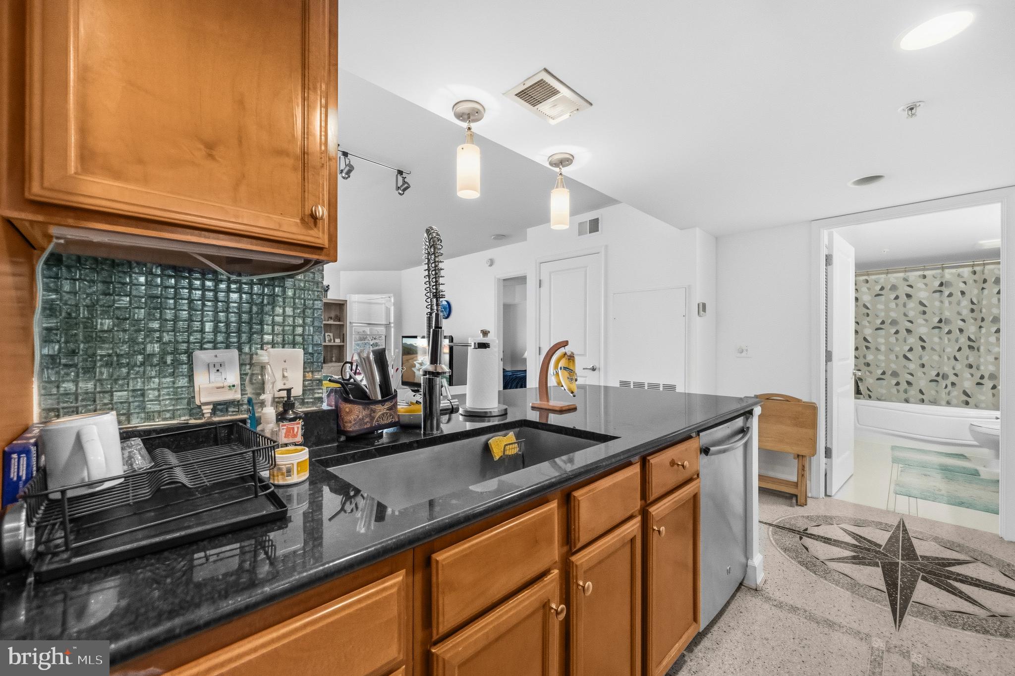 11800 Sunset Hills Road, Unit 726 Reston, VA 20190 - Photo 11 of 36 a kitchen with granite countertop a sink and cabinets