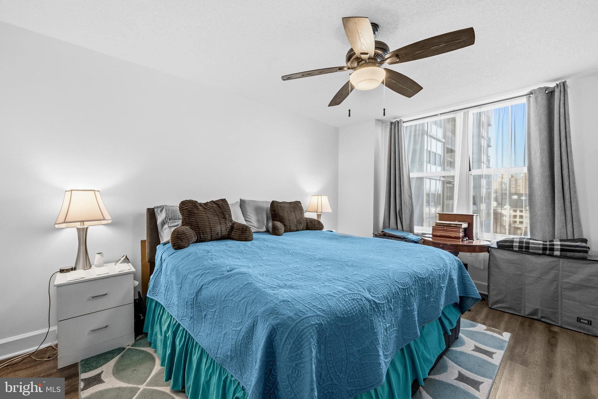 11800 Sunset Hills Road, Unit 726 Reston, VA 20190 - Photo 13 of 36 a spacious bedroom with a bed and a chandelier