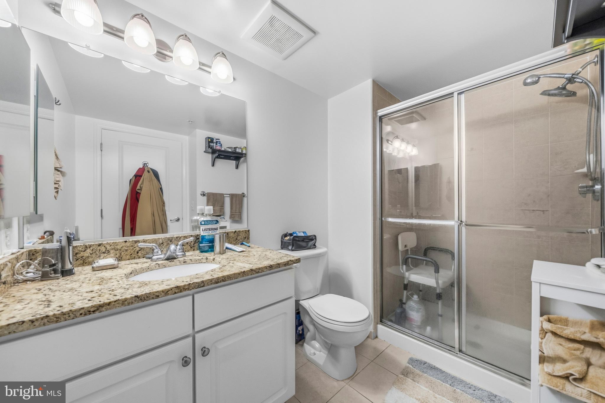 11800 Sunset Hills Road, Unit 726 Reston, VA 20190 - Photo 14 of 36 a bathroom with a granite countertop sink toilet and shower