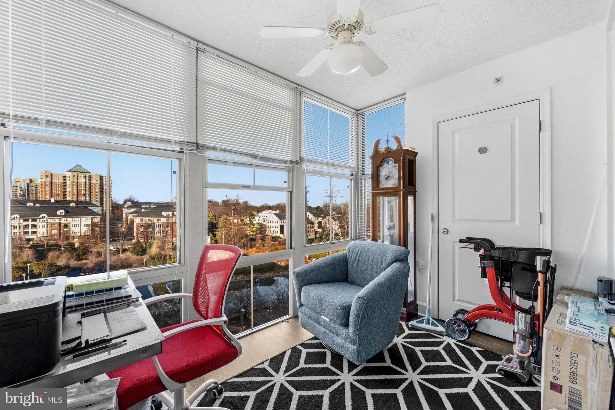 11800 Sunset Hills Road, Unit 726 Reston, VA 20190 - Photo 17 of 36 a living room with furniture a rug and a floor to ceiling window