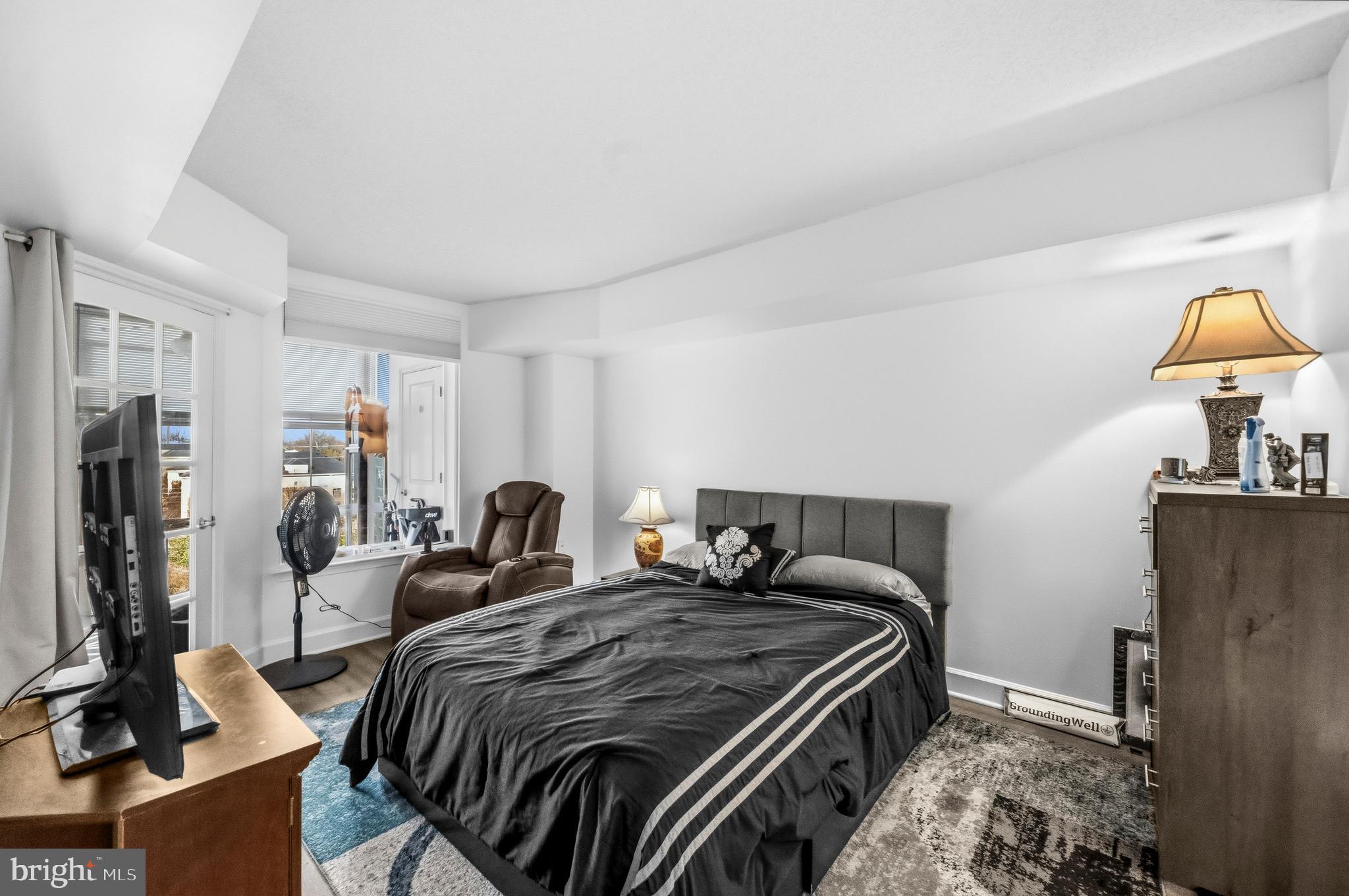 11800 Sunset Hills Road, Unit 726 Reston, VA 20190 - Photo 19 of 36 a bedroom with bed and a flat tv screen on dresser