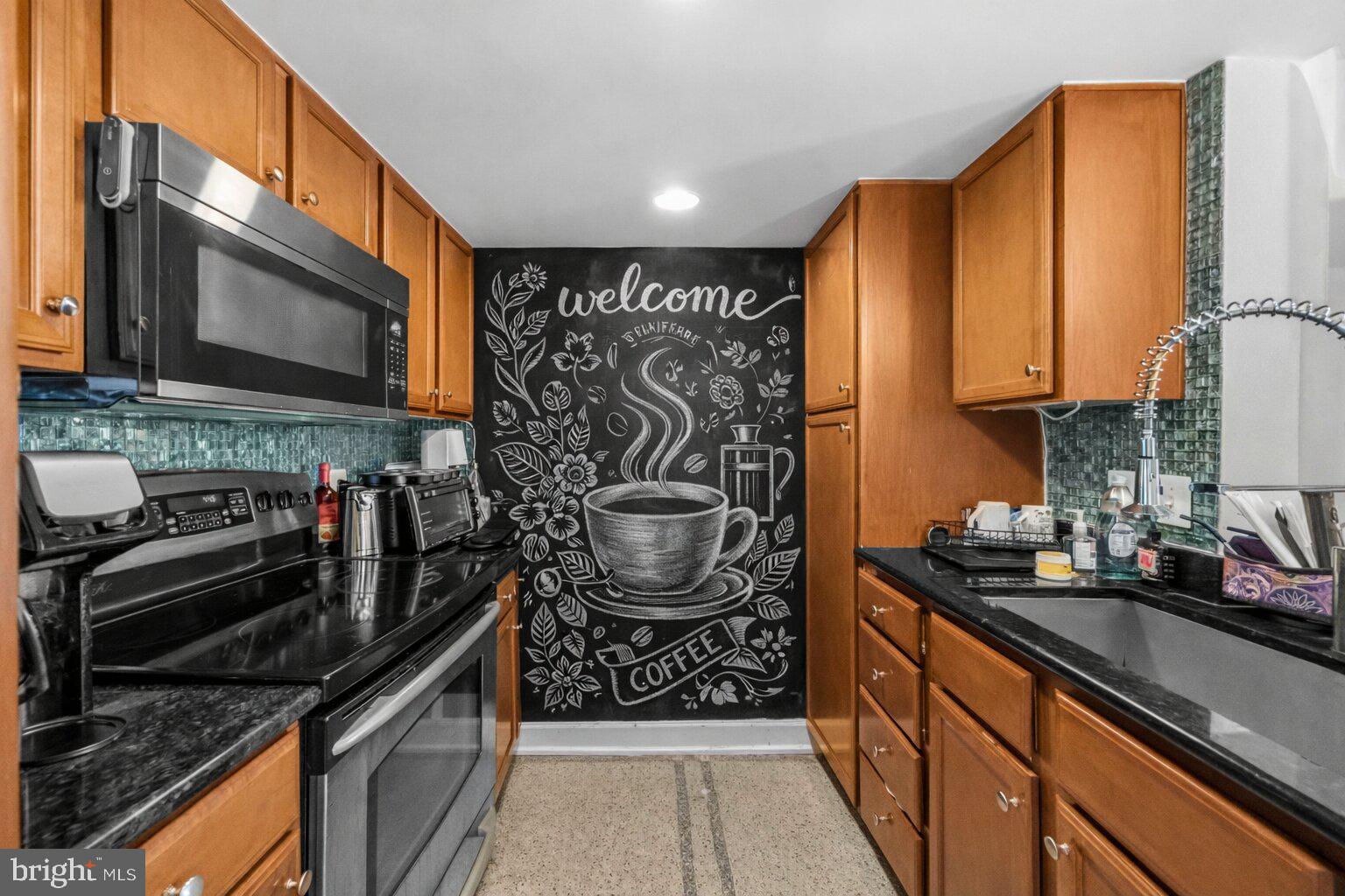 11800 Sunset Hills Road, Unit 726 Reston, VA 20190 - Photo 4 of 36 a kitchen with stainless steel appliances granite countertop a stove a sink and a microwave