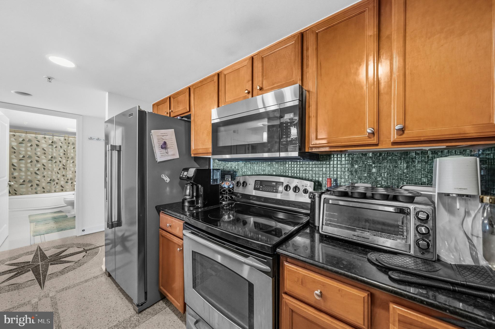 11800 Sunset Hills Road, Unit 726 Reston, VA 20190 - Photo 6 of 36 a kitchen with stainless steel appliances granite countertop a stove and a microwave