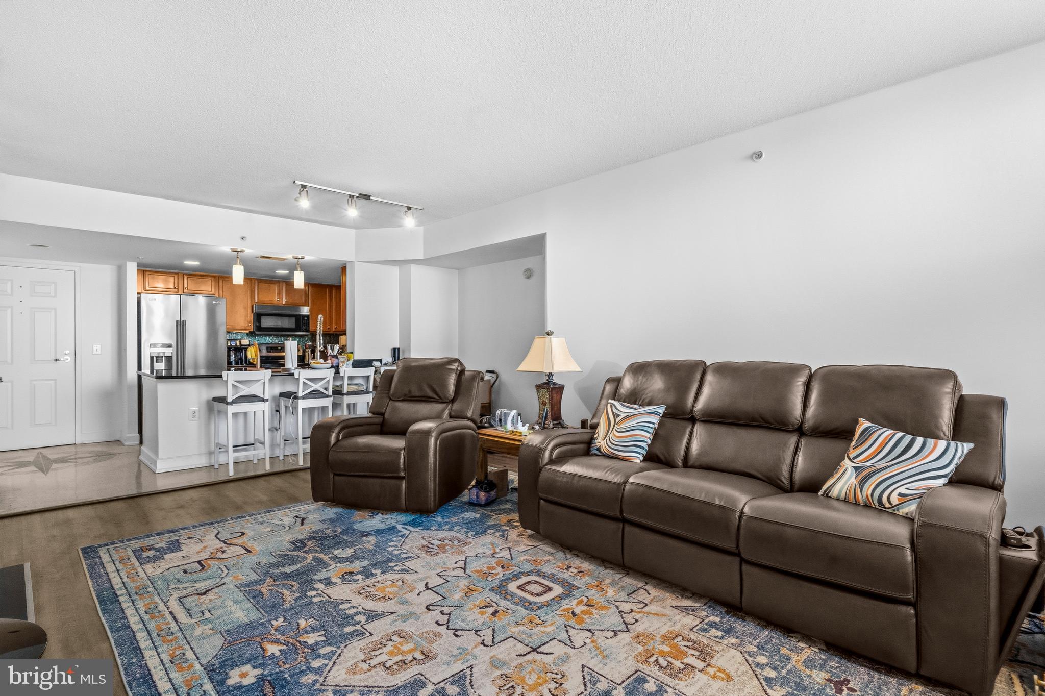 11800 Sunset Hills Road, Unit 726 Reston, VA 20190 - Photo 9 of 36 a living room with furniture wooden floor and a table
