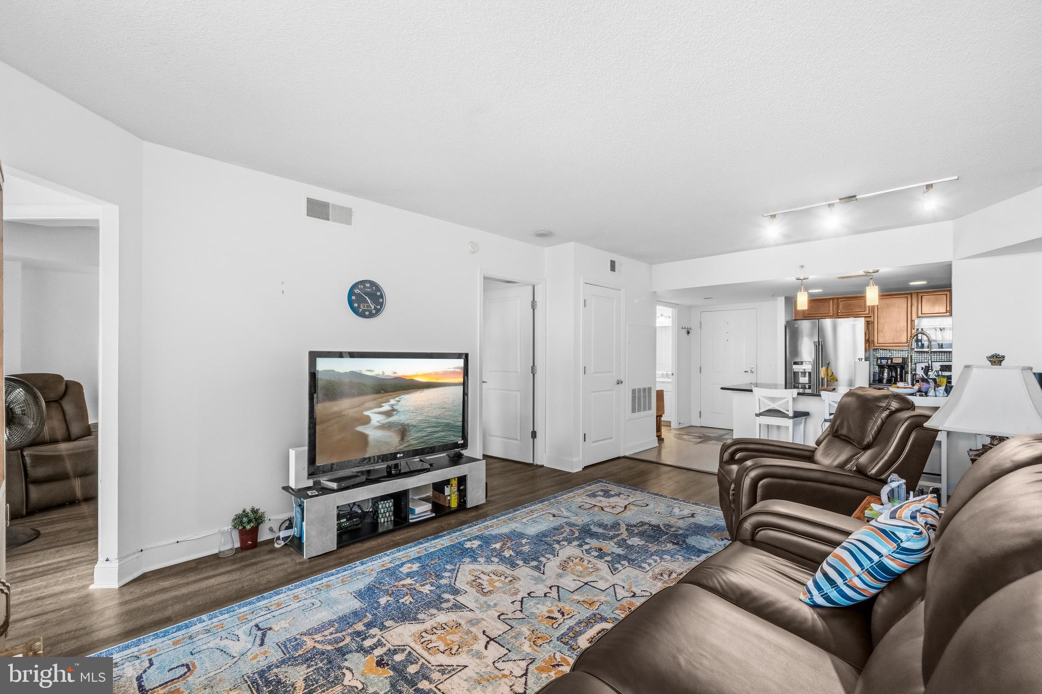 11800 Sunset Hills Road, Unit 726 Reston, VA 20190 - Photo 10 of 36 a living room with furniture and a flat screen tv