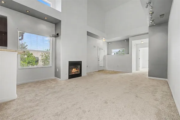 a view of empty room with a fireplace