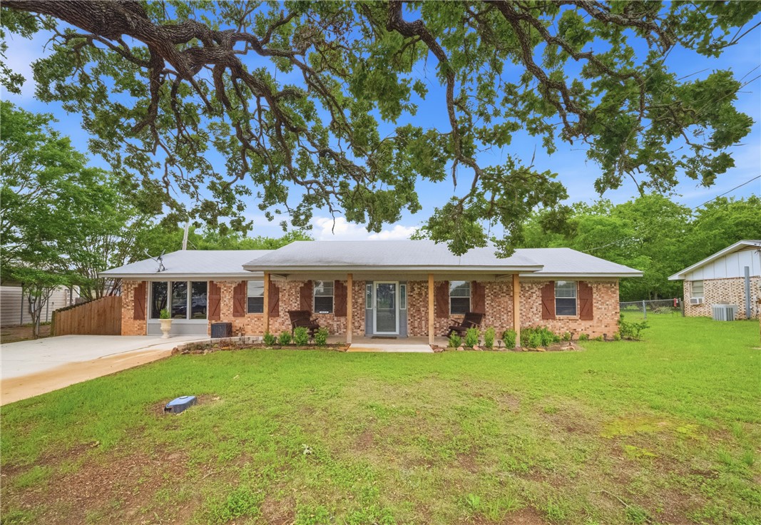 415 West Decherd Street Franklin, TX 77856 - Photo 1 of 28 a view of a house with a yard deck and a large tree