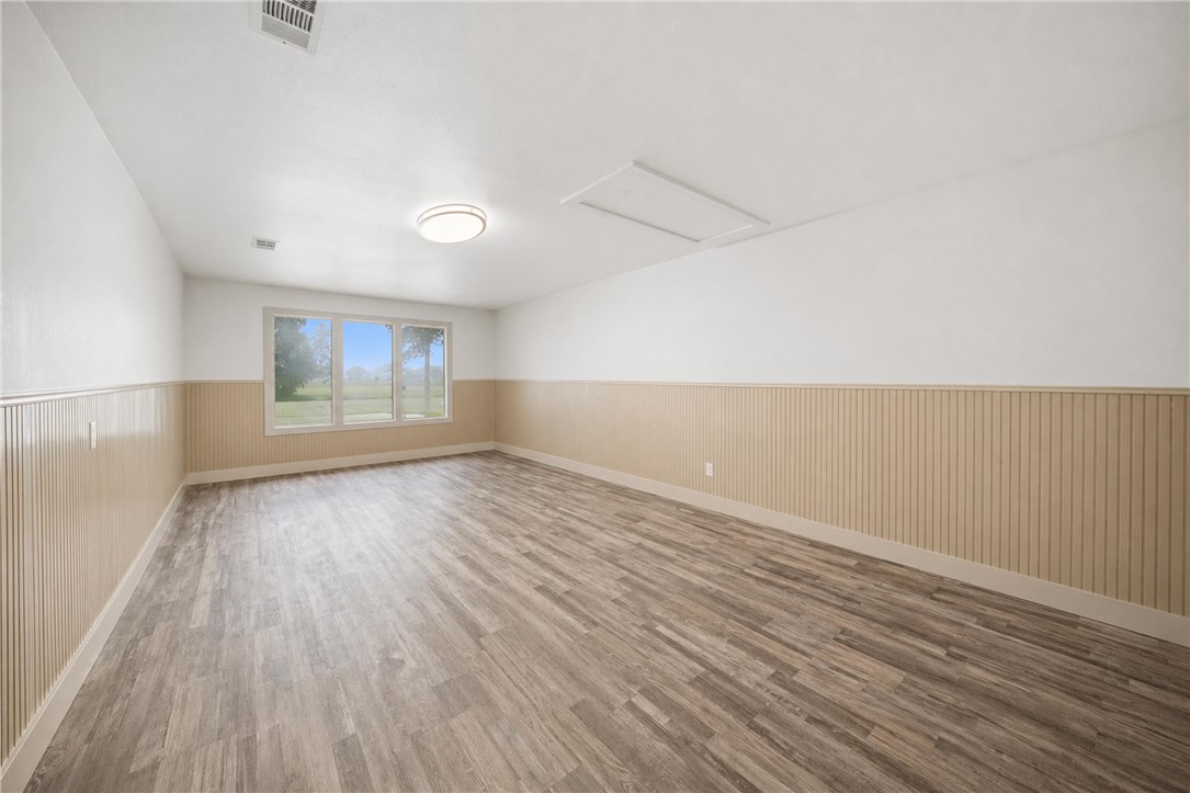 415 West Decherd Street Franklin, TX 77856 - Photo 21 of 28 an empty room with wooden floor and windows