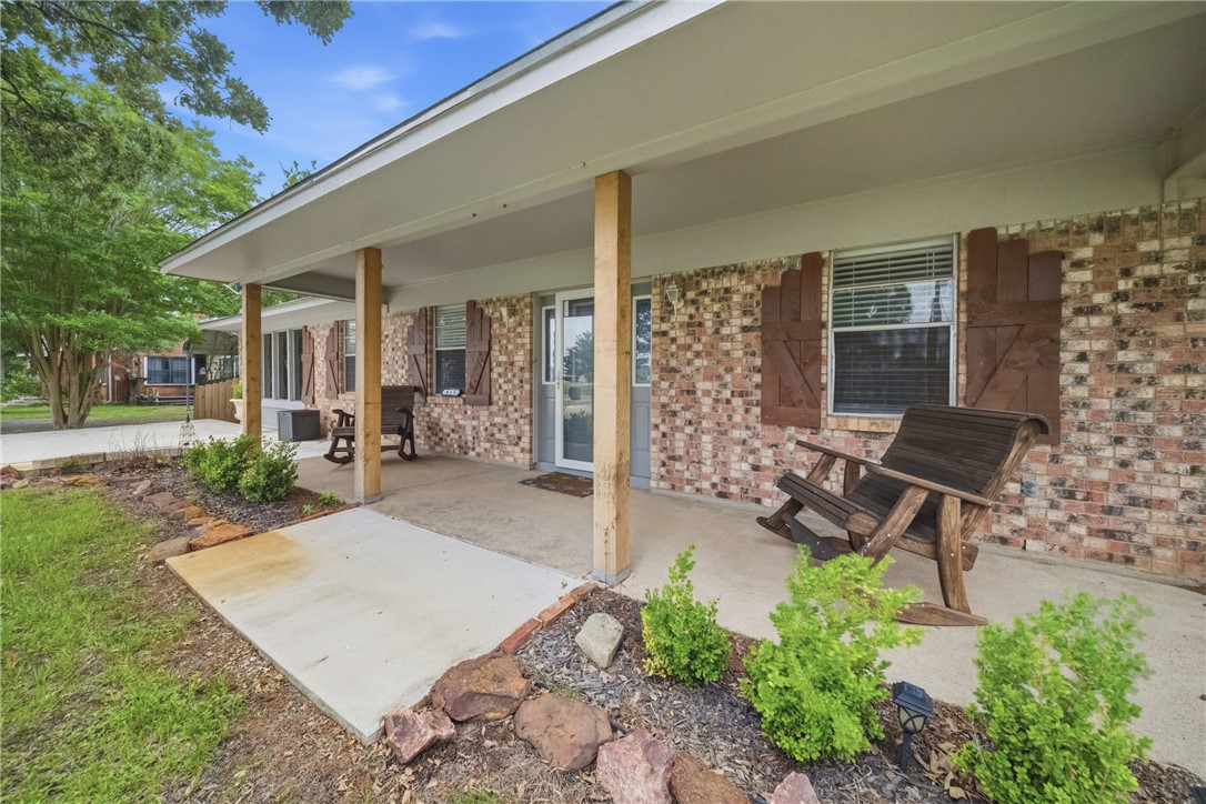 415 West Decherd Street Franklin, TX 77856 - Photo 24 of 28 a view of a patio with table and chairs potted plants and floor to ceiling window