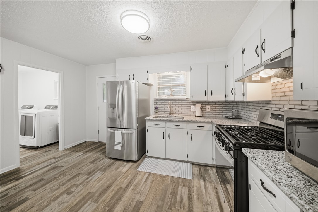 415 West Decherd Street Franklin, TX 77856 - Photo 9 of 28 a kitchen with a sink stove and refrigerator
