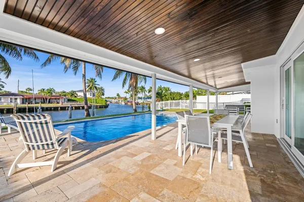 a view of swimming pool with outdoor seating and yard