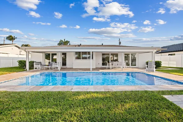 a view of a swimming pool with a table and chairs