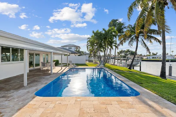 a view of a house with swimming pool and sitting area