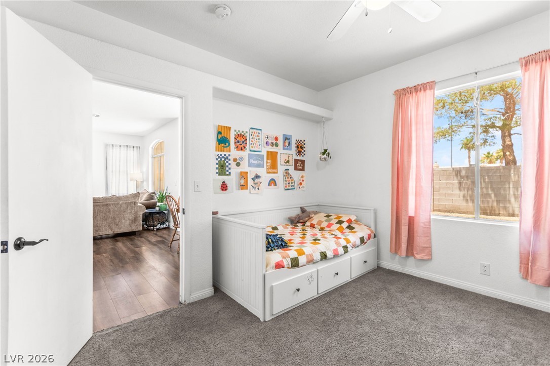 7353 Ridge Star Court Las Vegas, NV 89131 - Photo 23 of 36 A well-lit bedroom features plush carpeting and a convenient daybed with integrated storage.