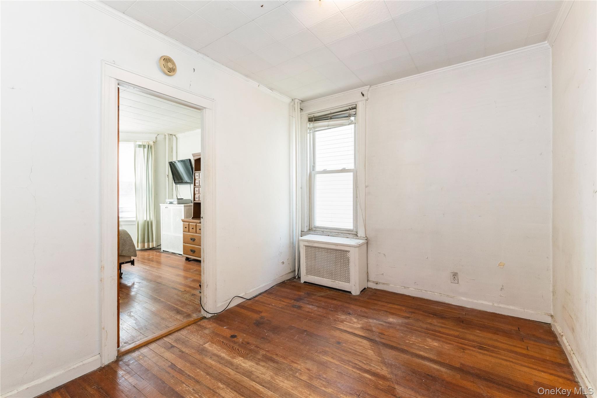 82-72 88th Place Queens, NY 11421 - Photo 7 of 26 wooden floor in an empty room