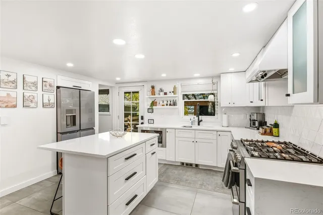 a kitchen with appliances a sink and cabinets