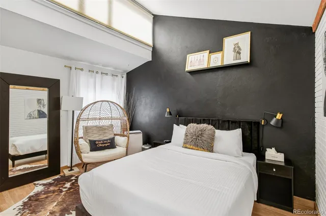 a bedroom with a bed and a night stand