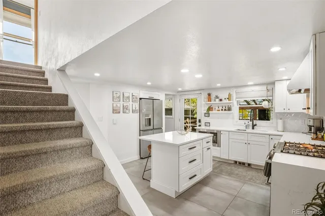 a large white kitchen with cabinets and white appliances