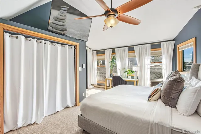 a bedroom with a large bed and a large window