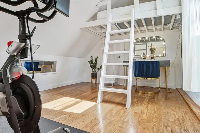 a view of a livingroom with furniture and staircase