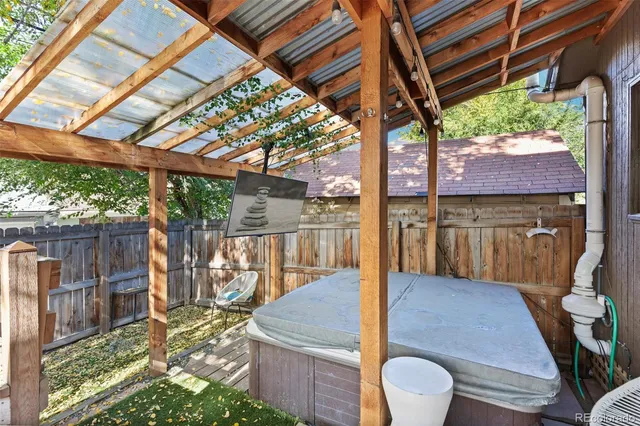 a view of a porch with furniture and wooden floor