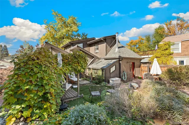 a backyard of a house with table and chairs