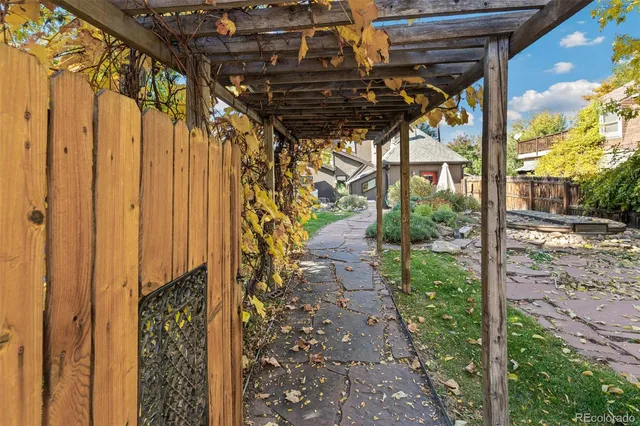 a view of backyard with wooden fence