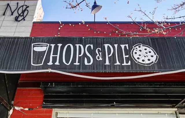 a view of a cafe with a table and chairs under an umbrella