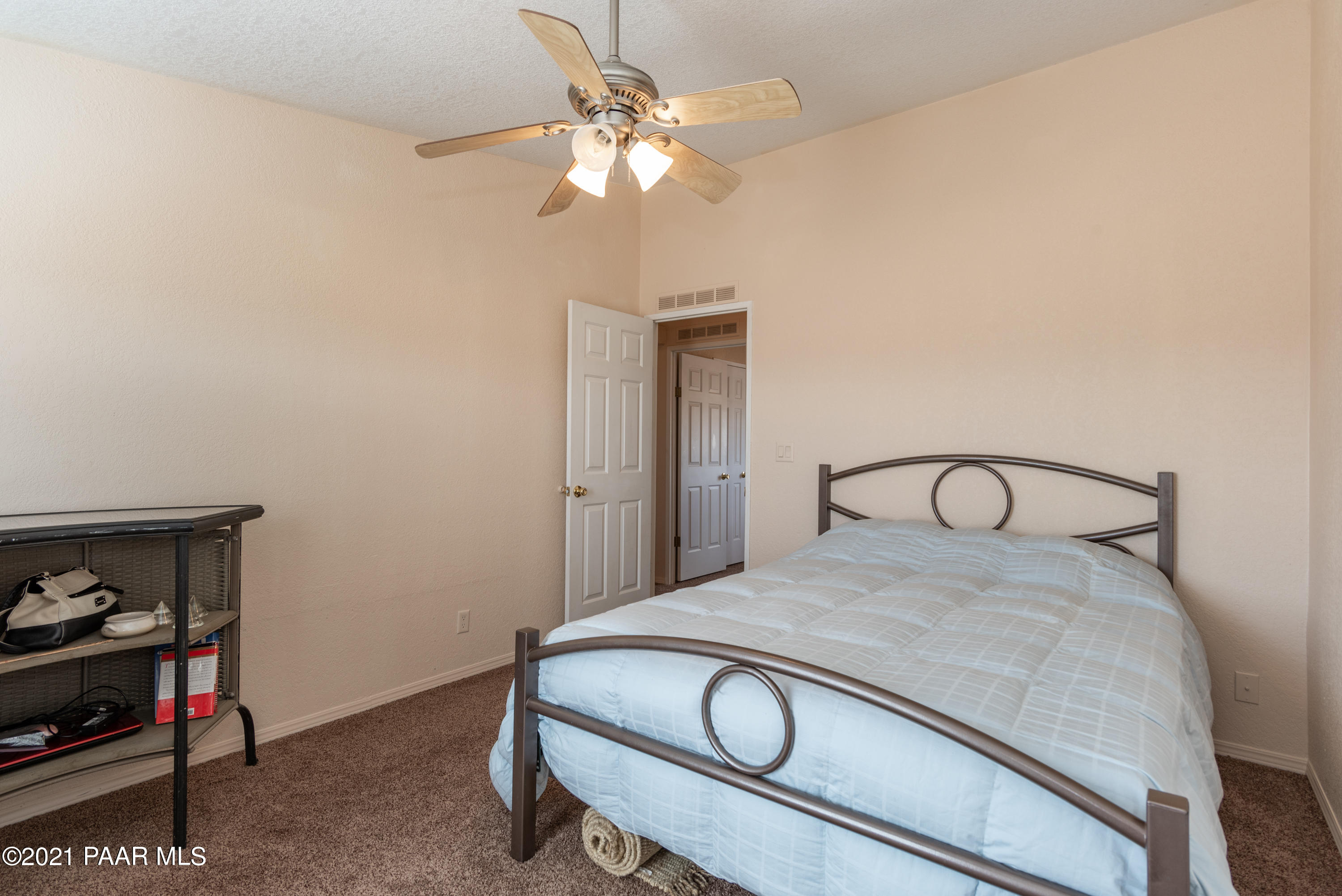 1625 West Antelope Run Road Paulden, AZ 86334 - Photo 18 of 35 a bedroom with a bed and a chandelier