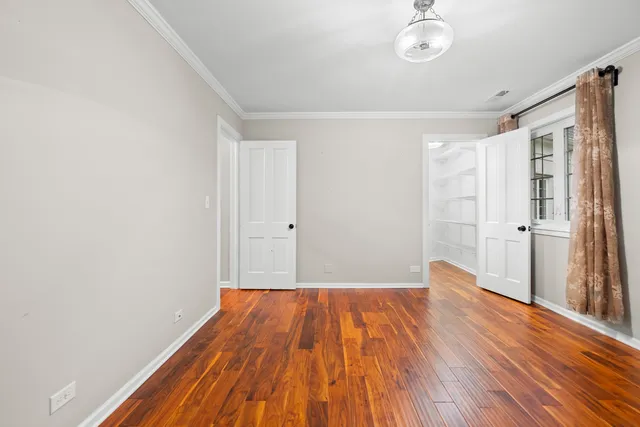 a view of a room with wooden floor and a sink