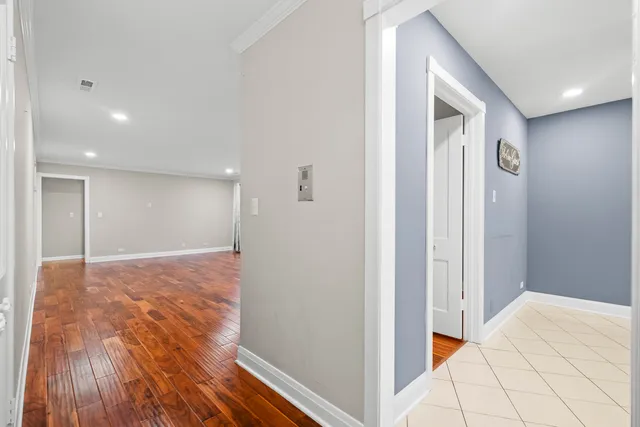 a view of an empty room and wooden floor