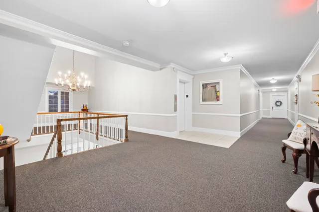 a view of a livingroom with furniture and a chandelier