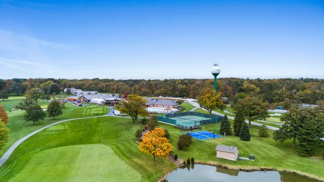 a view of a house with a yard and lake view