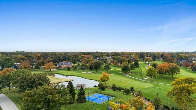 an aerial view of a residential houses with outdoor space and street view