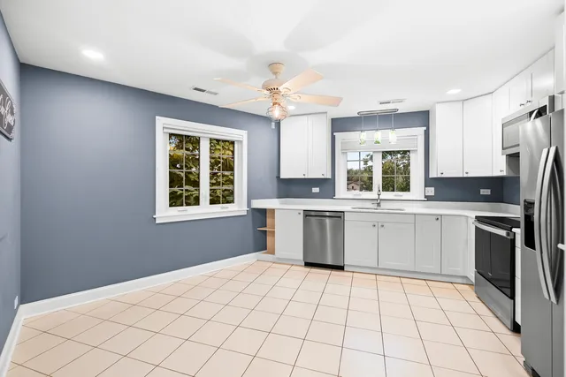 a kitchen with a stove a sink and a refrigerator