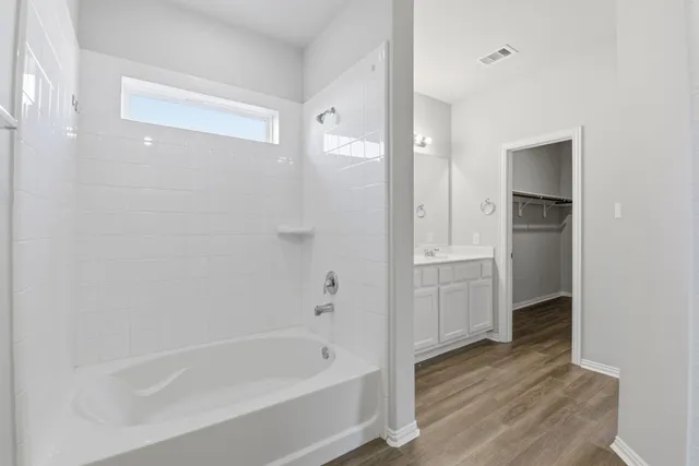 a bathroom with a bathtub and a shower