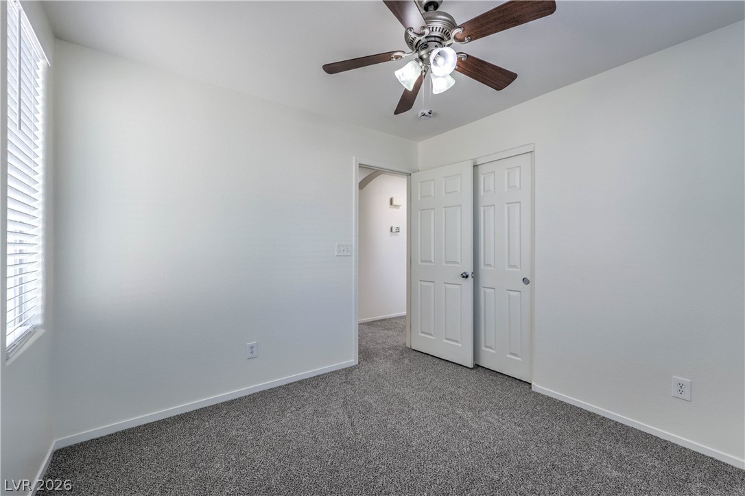 10939 Paradise Road Henderson, NV 89052 - Photo 28 of 36 Well-lit room with plush carpet, bright white walls, and a convenient closet.