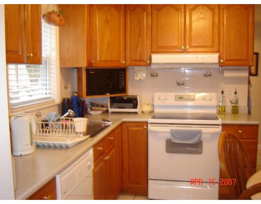 17 Waring Road Natick, MA 01760 - Photo 2 of 13 a kitchen with stainless steel appliances granite countertop a sink a stove and a refrigerator with wooden floor