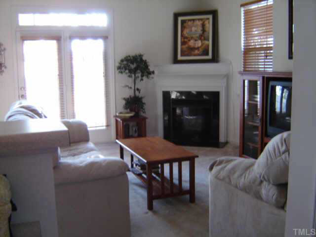 8237 Martello Lane Raleigh, NC 27613 - Photo 1 of 10 a living room with furniture and a fireplace