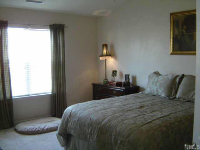 8237 Martello Lane Raleigh, NC 27613 - Photo 6 of 10 a bedroom with a bed and window