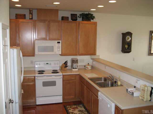 8237 Martello Lane Raleigh, NC 27613 - Photo 8 of 10 a kitchen with a sink stove and refrigerator