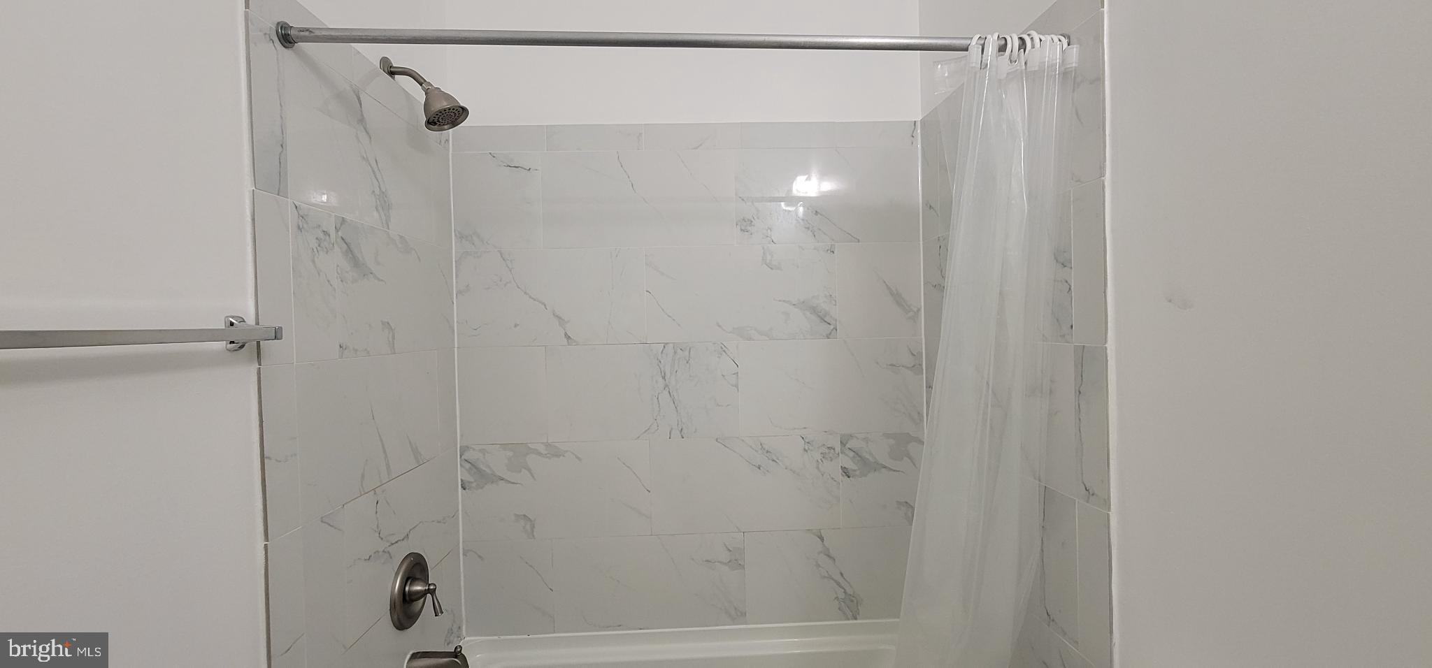 356 Main Street, Unit 300 Gaithersburg, MD 20878 - Photo 15 of 23 Sleek, modern shower with elegant tiles.